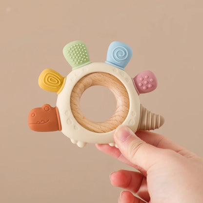 Anneau de dentition en silicone dinosaure avec anneau en bois – sûr et apaisant pour les bébés qui font leurs dents